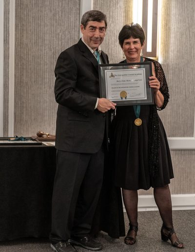 OCAF President, Dr. Dolgin stands next to a woman, both hold a certificate