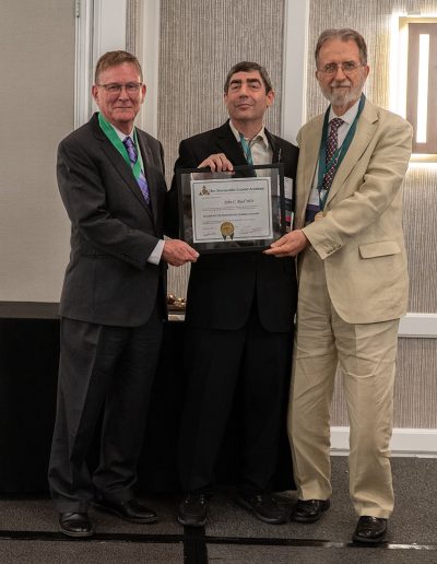 OCAF President, Dr. Dolgin stands next to two men, all holding a certificate